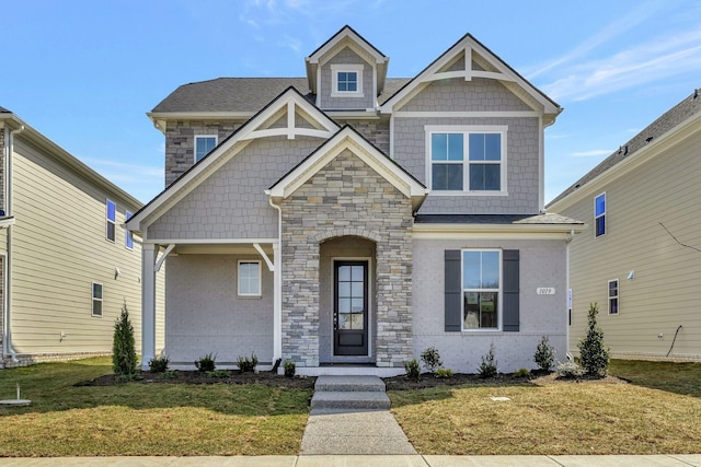 craftsman house with a front lawn