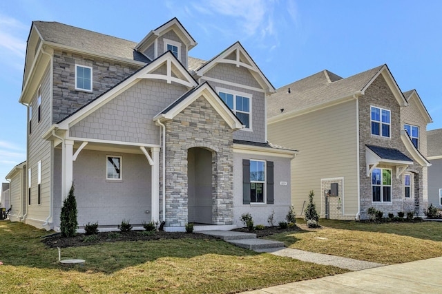 craftsman inspired home featuring stone siding and a front yard