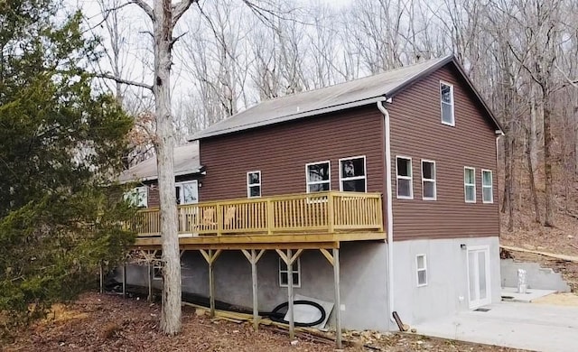 back of property with a wooden deck