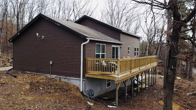 view of side of property featuring metal roof and a deck