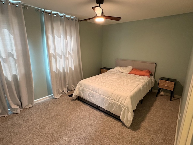 carpeted bedroom featuring ceiling fan and baseboards