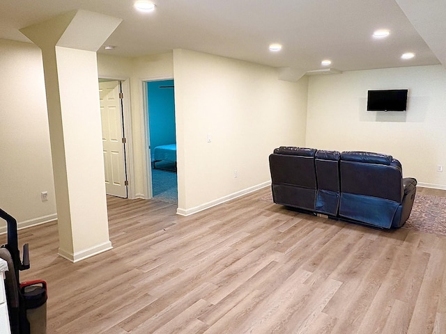 living room featuring baseboards, light wood-style flooring, and recessed lighting