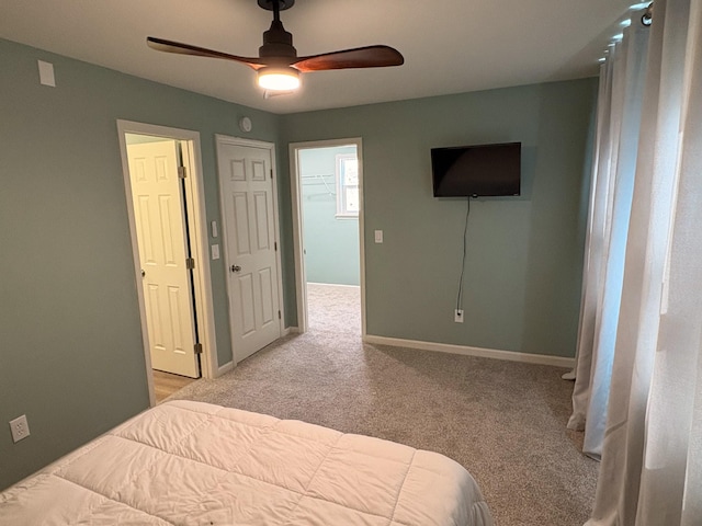 bedroom featuring light carpet, ceiling fan, and baseboards