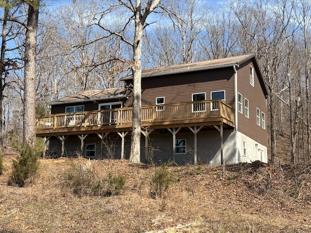 rear view of house featuring a deck