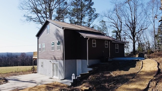 view of side of home featuring metal roof