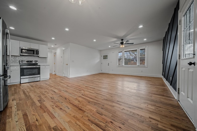 unfurnished living room featuring light wood-style flooring, baseboards, ceiling fan, and recessed lighting