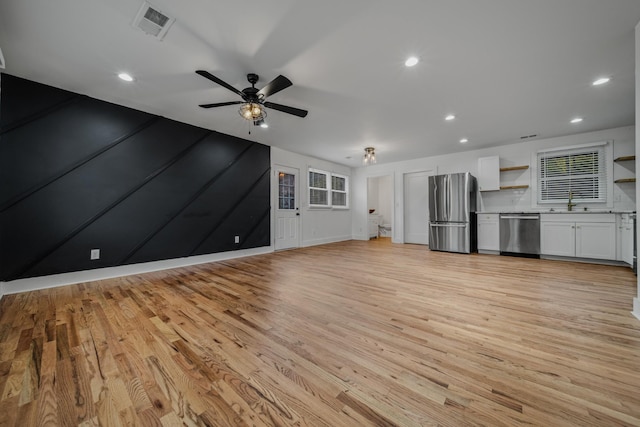 unfurnished living room featuring a ceiling fan, recessed lighting, visible vents, and light wood-style floors