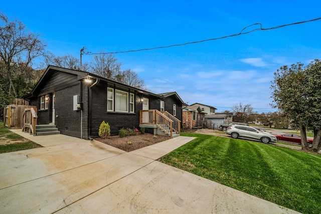 view of front of property with a front yard and brick siding