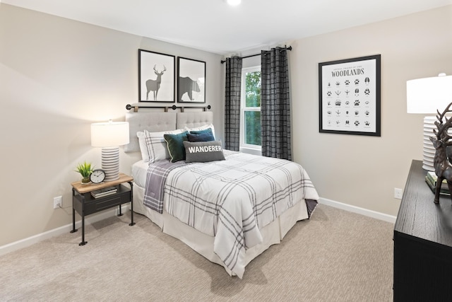 carpeted bedroom featuring baseboards