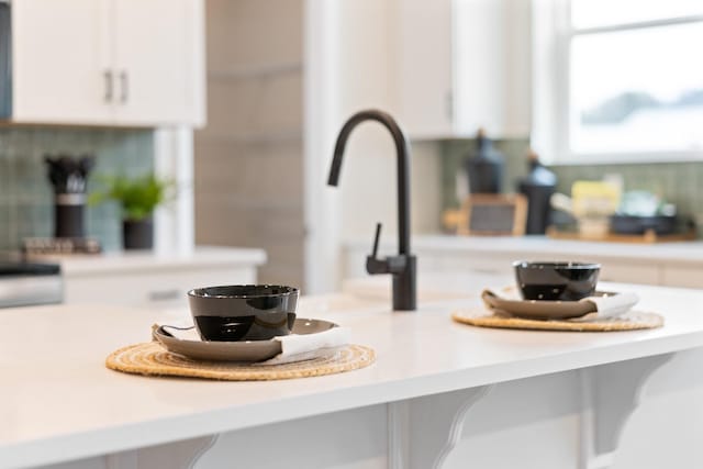 room details featuring white cabinetry and light countertops