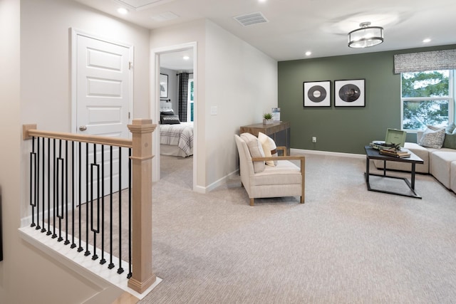 living area featuring carpet, visible vents, baseboards, and recessed lighting