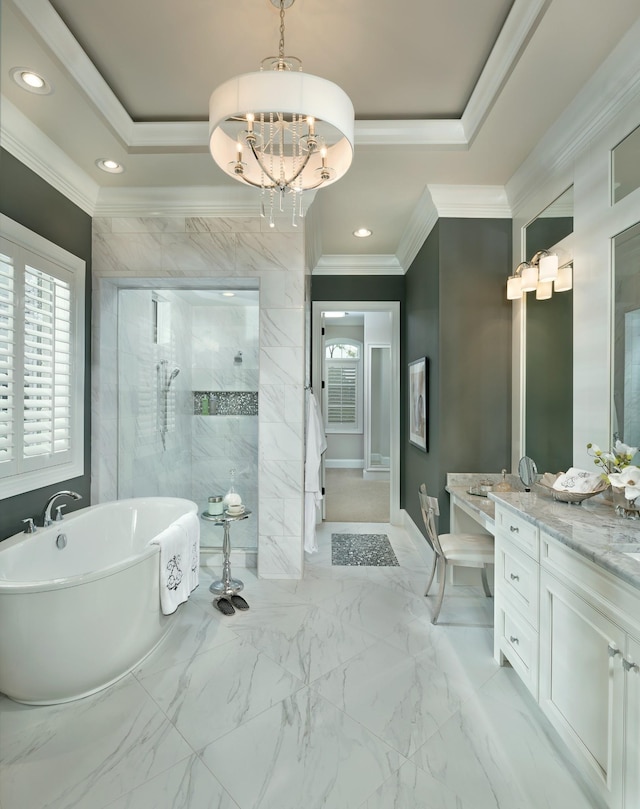 bathroom with a raised ceiling, ornamental molding, marble finish floor, a tile shower, and a freestanding tub