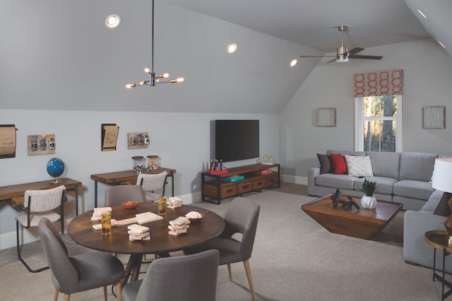 dining space featuring lofted ceiling, carpet, baseboards, and ceiling fan with notable chandelier