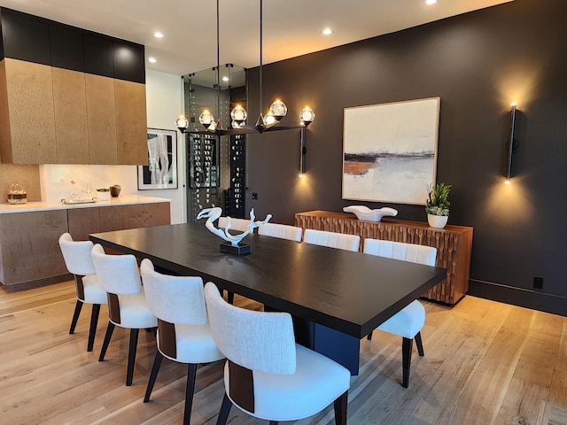 dining room featuring light wood-type flooring, baseboards, and recessed lighting