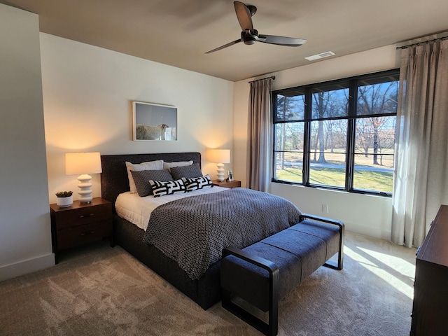 bedroom featuring a ceiling fan, carpet, visible vents, and baseboards