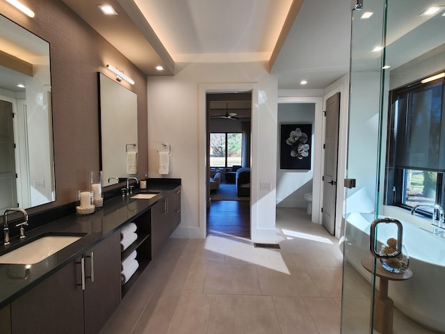 full bath with tile patterned flooring, a sink, toilet, and double vanity