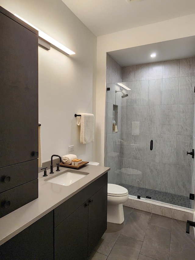 bathroom featuring a stall shower, vanity, and toilet