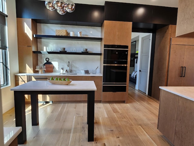 interior space with modern cabinets, open shelves, a sink, and a warming drawer