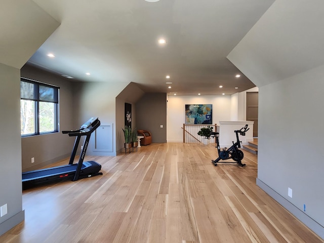 exercise area with baseboards, light wood-style flooring, and recessed lighting