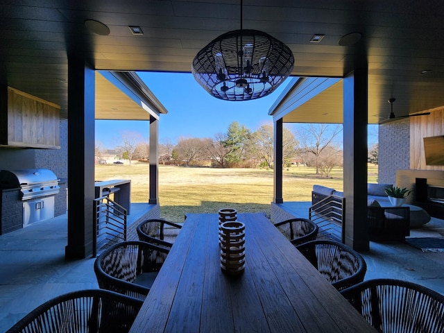 view of patio with outdoor dining space, ceiling fan, and area for grilling