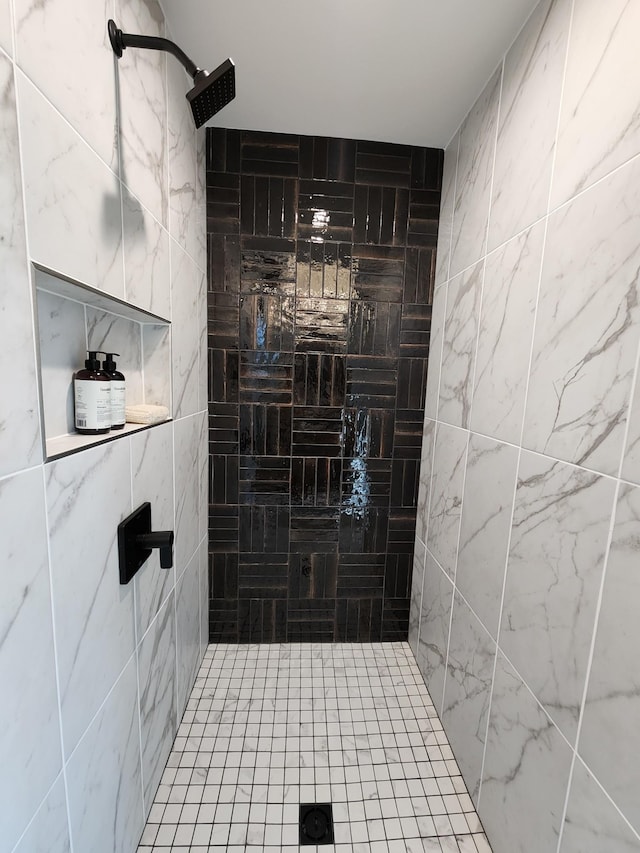 bathroom with a tile shower