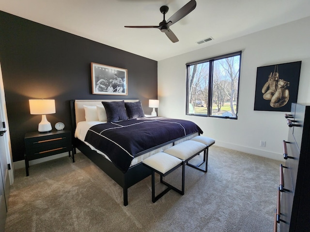 carpeted bedroom with baseboards, visible vents, and a ceiling fan