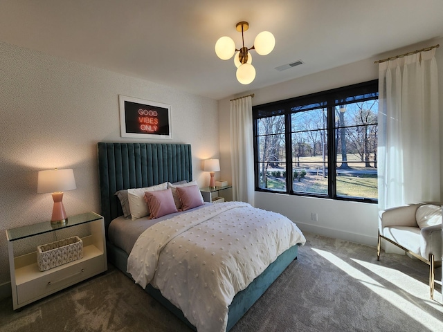 carpeted bedroom featuring visible vents, baseboards, and wallpapered walls