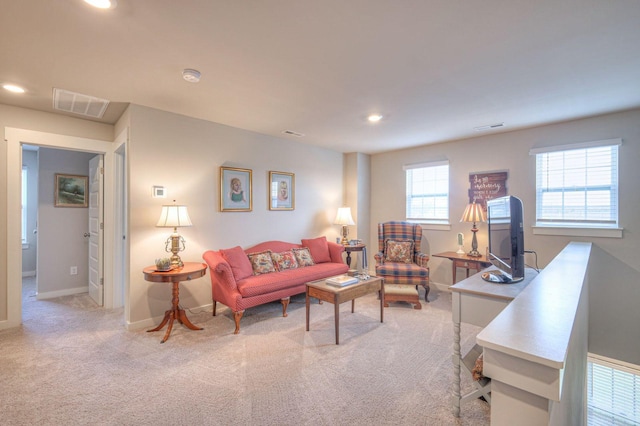 carpeted living room featuring baseboards, visible vents, and recessed lighting