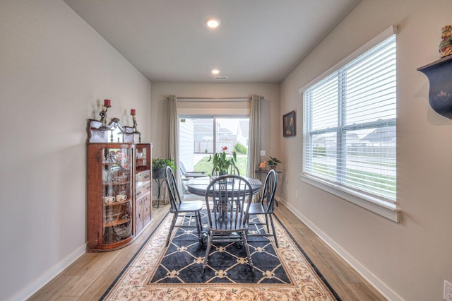 dining area with light wood-style floors, visible vents, baseboards, and recessed lighting