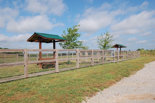 view of yard with a rural view and fence