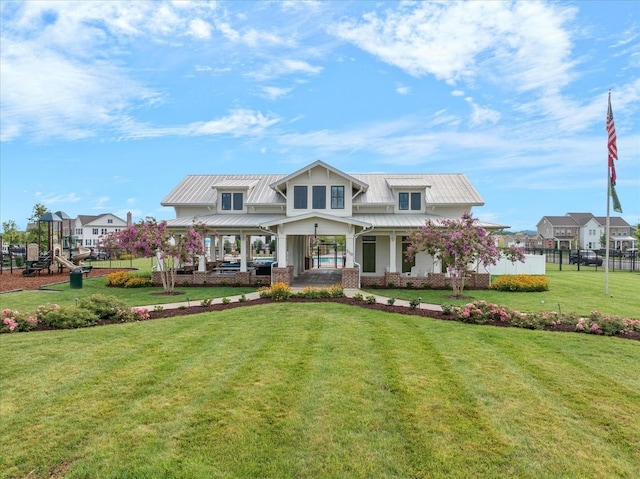 craftsman inspired home featuring a standing seam roof, metal roof, and a front lawn