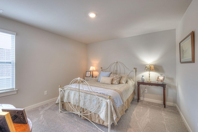 bedroom with carpet floors, multiple windows, and baseboards