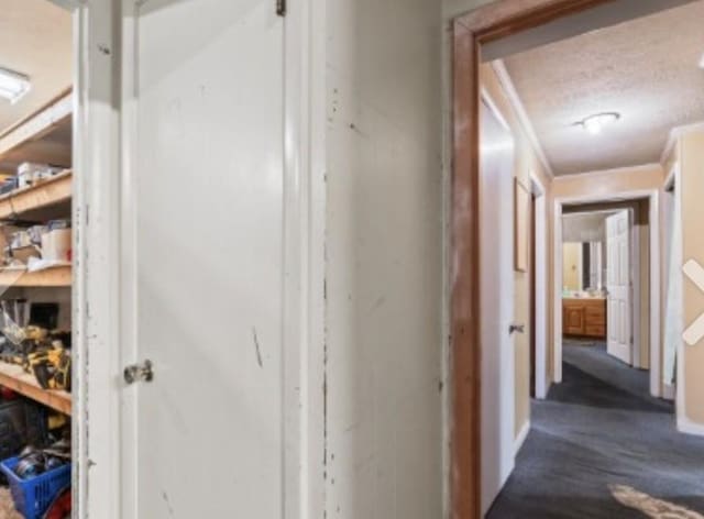 corridor featuring a textured ceiling