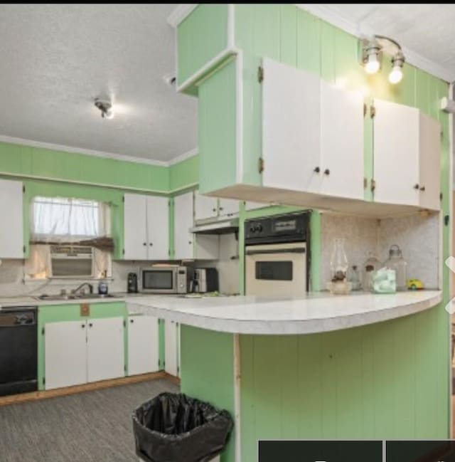 kitchen featuring stainless steel microwave, decorative backsplash, ornamental molding, oven, and dishwasher