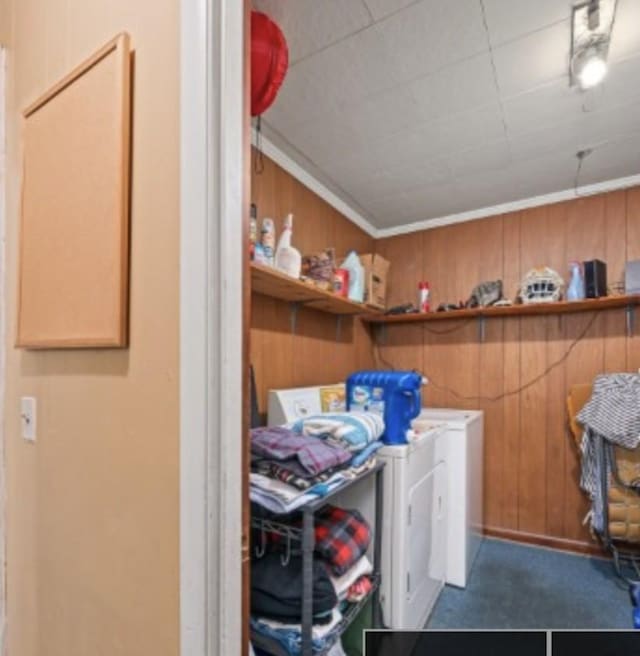 laundry area featuring laundry area, separate washer and dryer, and wood walls