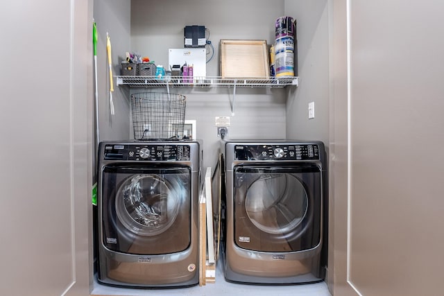 clothes washing area with laundry area and washing machine and clothes dryer