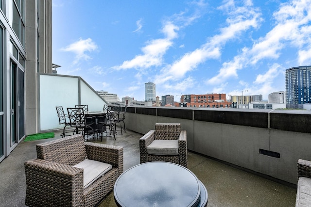 view of patio with a view of city and outdoor dining space