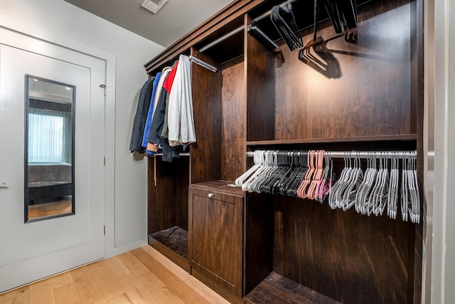 spacious closet with visible vents and light wood-style flooring