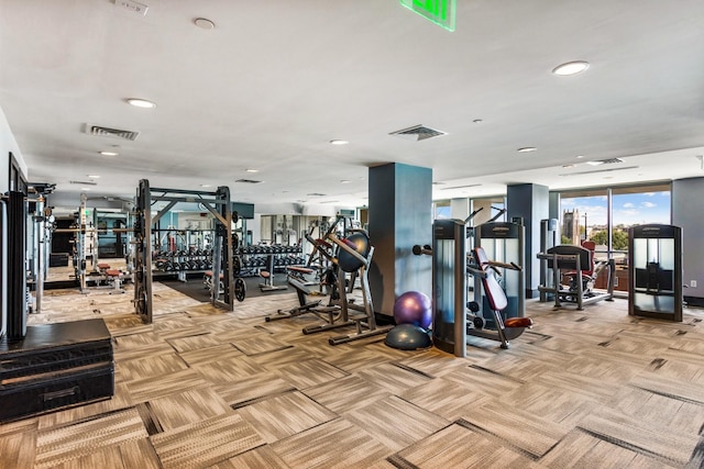 exercise room with visible vents and light colored carpet