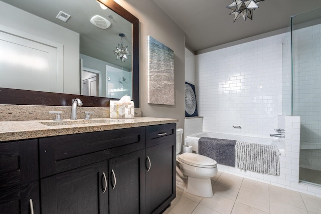 bathroom with a garden tub, visible vents, toilet, vanity, and tile patterned flooring