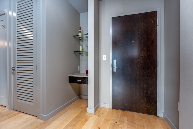 entrance foyer featuring light wood-style flooring and baseboards