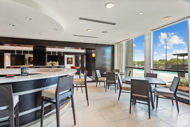 dining room featuring recessed lighting, light tile patterned flooring, visible vents, and floor to ceiling windows