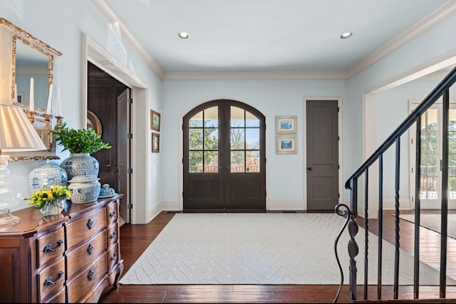 entrance foyer featuring dark wood-type flooring, french doors, stairway, and plenty of natural light