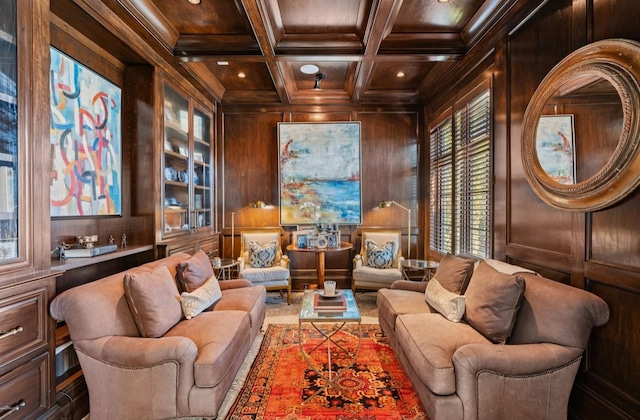 living area with wood walls, coffered ceiling, wood ceiling, ornamental molding, and beam ceiling