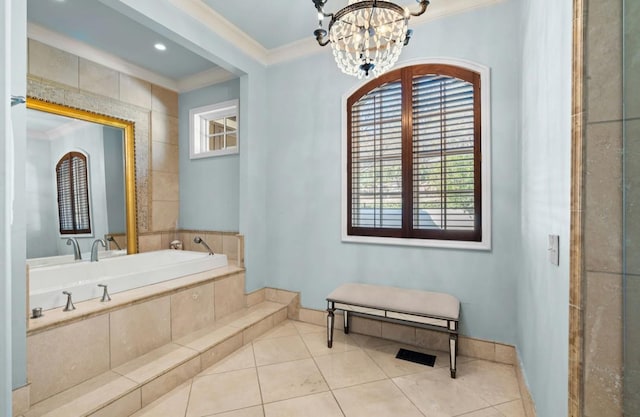 bathroom with baseboards, ornamental molding, tile patterned floors, a garden tub, and a notable chandelier