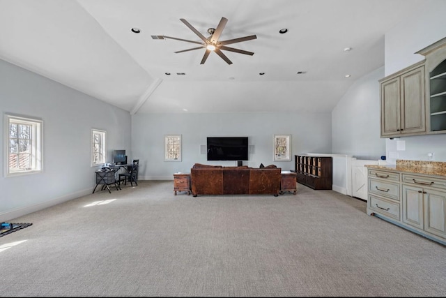 living room with vaulted ceiling, baseboards, and light colored carpet