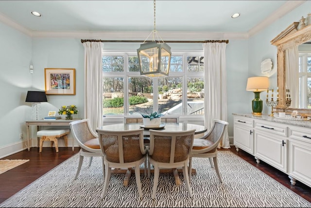 dining room with plenty of natural light, baseboards, and dark wood finished floors