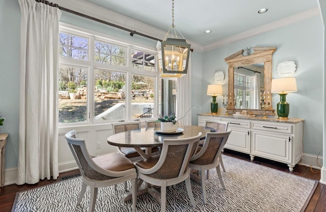 dining space featuring a healthy amount of sunlight, crown molding, baseboards, and dark wood-style flooring