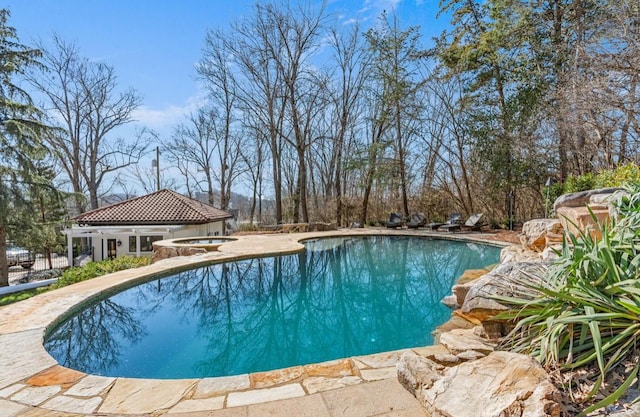 outdoor pool featuring a hot tub