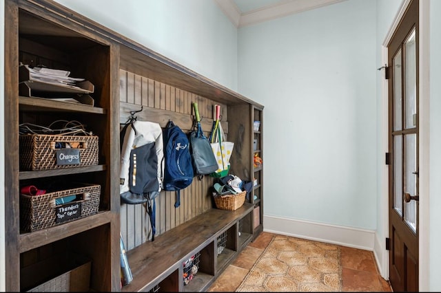 mudroom featuring stone finish floor, baseboards, and ornamental molding